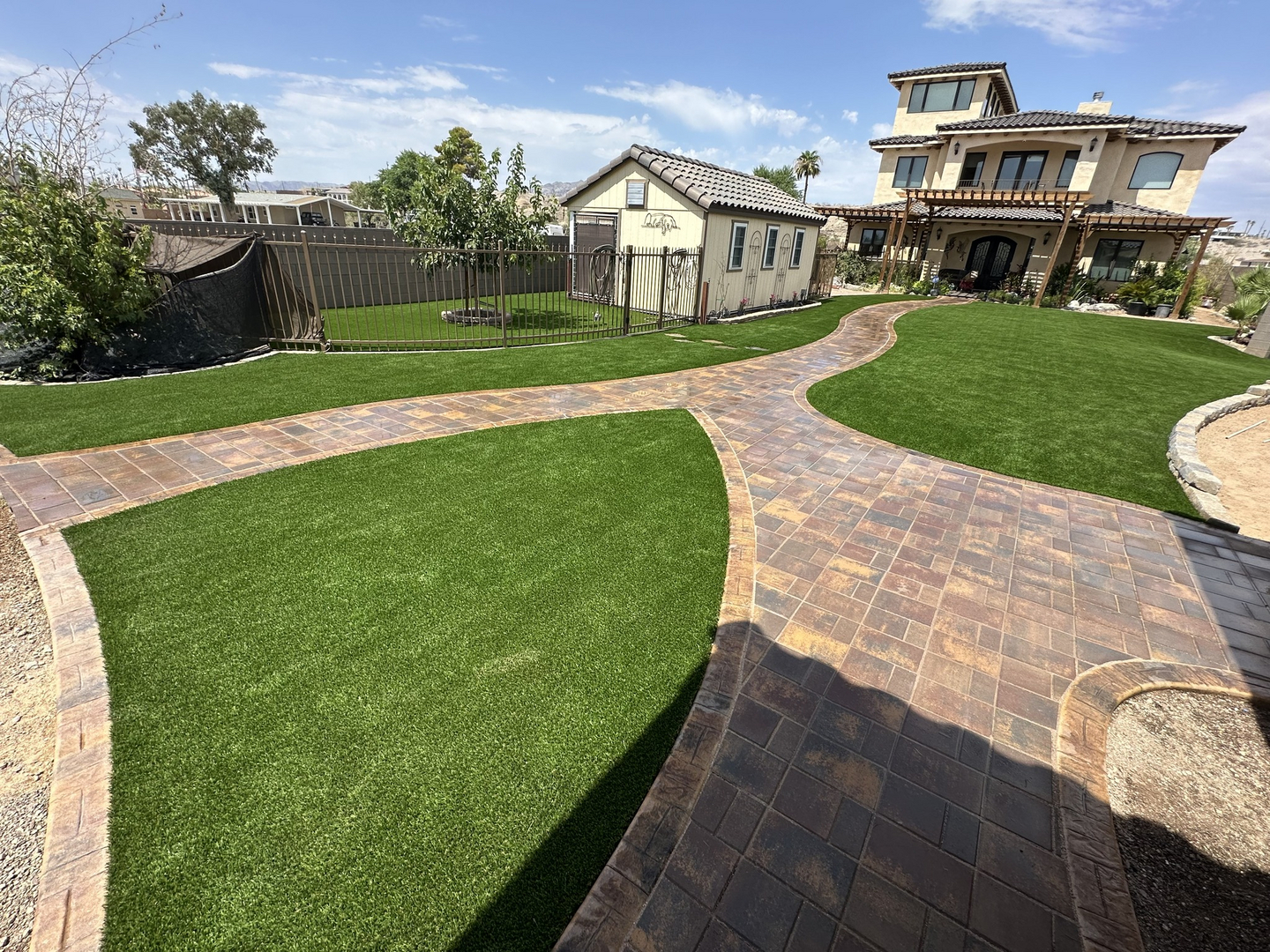 Front yard artificial turf with paver walkway